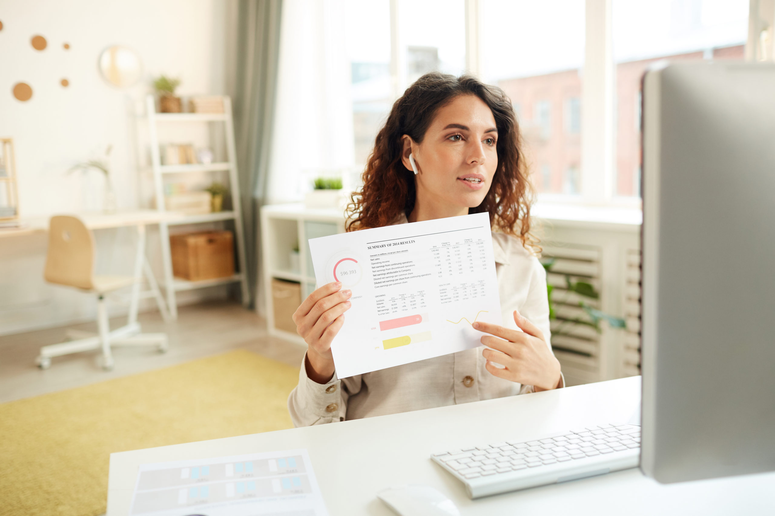 Young businesswoman reporting on new project results during video conference, horizontal medium shot