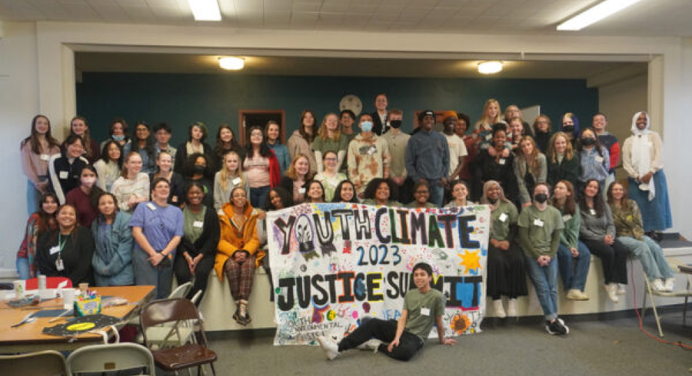 group holding a banner with statement about climate